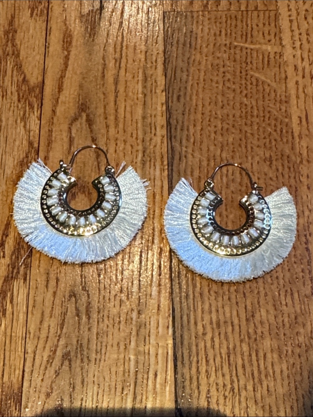 Gold and white tassel hoop earrings